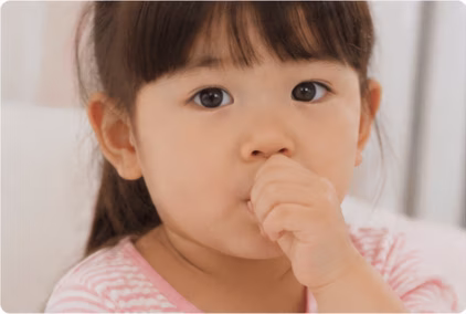Young child sucking their thumb